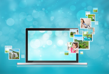 Open laptop at blue background. Pictures are flying out of the s