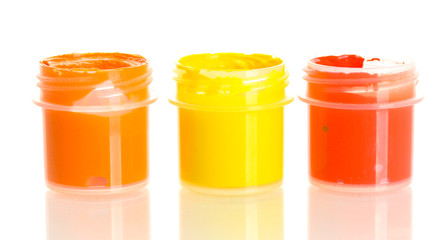 jars with multicolored gouache isolated on white background