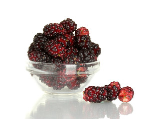 Transparent bowl with ripe mulberries isolated on white