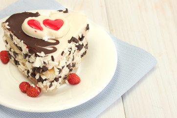 sweet cake with chocolate on plate on wooden table