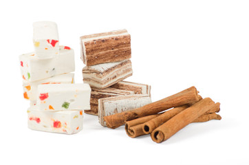 Sweets and cinnamon sticks isolated on white background