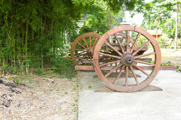 Fototapeta na wymiar Old wagon wheel near the bamboo grove.