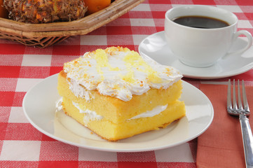 Lemon cake with coffee on a picnic table