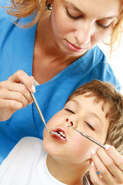 The boy with a doctor in a dental surgery.