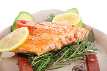 hot baked salmon piece served with vegetables