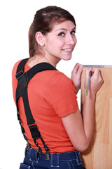 Woman measuring laminate flooring