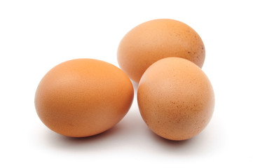 three chicken eggs on white background