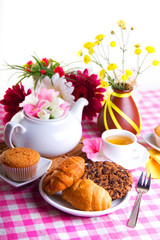 breakfest with tea, cake and yellow flowers