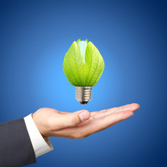 Concept of energy saving light bulbs on Business hand