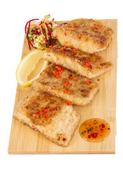 Fried fish fillets with  salad.