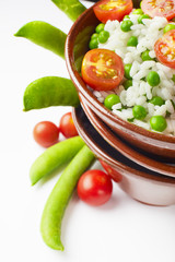 bowl of rice with tomatoes and peas