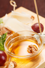 Cheese plate with grapes and honey