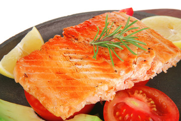 hot baked salmon piece served with vegetables