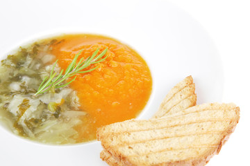 vegetable soup served with toasts on white dish