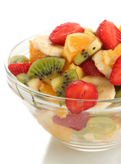 glass bowl with fresh fruits salad isolated on white