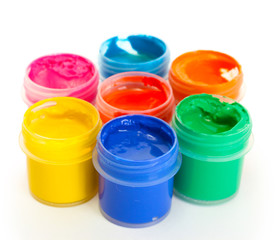 jars with multicolored gouache isolated on white background