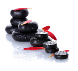 Spa stones with drops and petals isolated on white