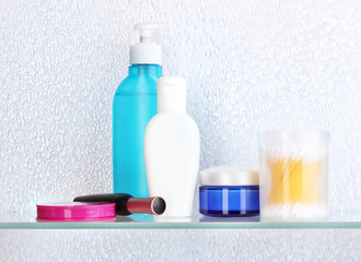 Shelf with cosmetics and toiletries in bathroom