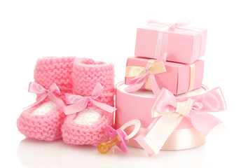 pink baby boots,  pacifier and gifts isolated on white