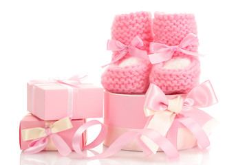 pink baby boots and gifts isolated on white