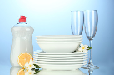 Fototapeta na wymiar empty clean plates and glasses with dishwashing liquid and