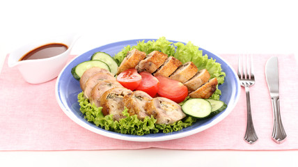 Tasty meat cutlet with garnish on plate isolated on white