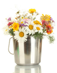 beautiful bouquet of bright  wildflowers in metal bucket,