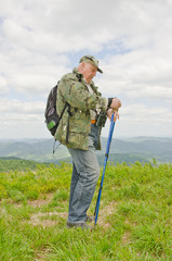 Senior birdwatcher trekking in mountains (Bieszczady, Poland)