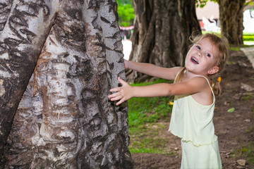 Girl hugging a tree