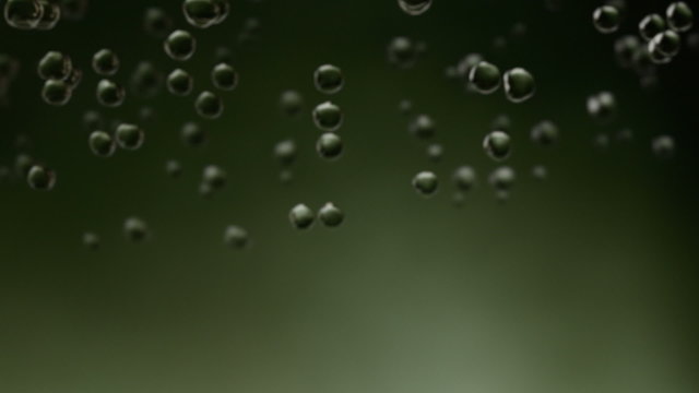 An animation of falling raindrops, close up and slow motion