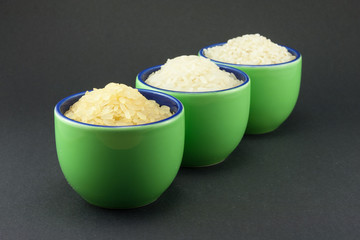 Three varieties of rice in three small green cups