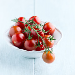 Cherry tomatoes on the vine in a bowl