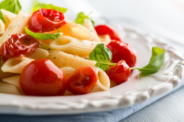 Penne pasta with cherry tomatoes and basil