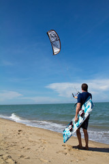 kitesurfer and his kite at sky background