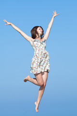 Girl jumping on background of sky