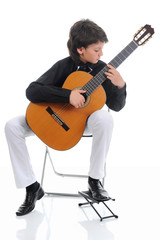 Obraz premium Little boy musician playing guitar