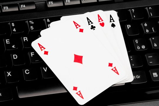 playing cards on computer keyboard - internet games concept