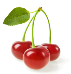 Three cherries with leaf isolated on a white background