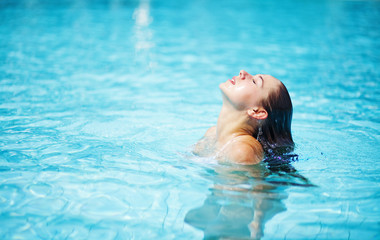 Young woman in the swimming pool - obrazy, fototapety, plakaty