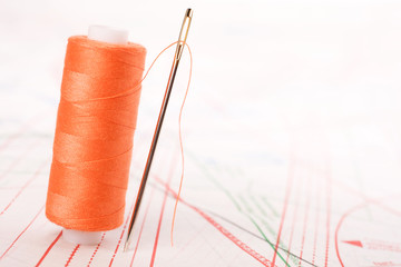 Spool of thread and needle. Sew accessories.