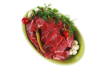 meat chunks on ceramic bowls with vegetables