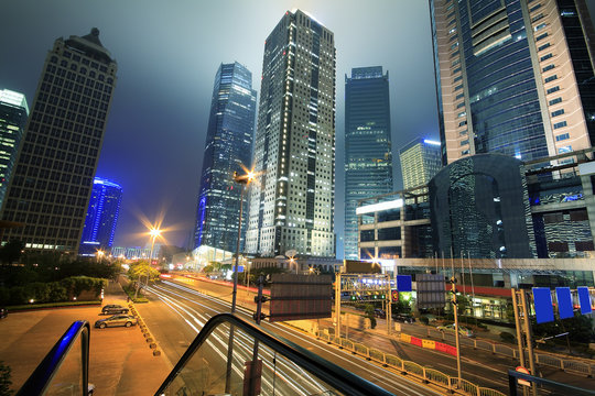 View traffic through modern cityscape at night in shanghai