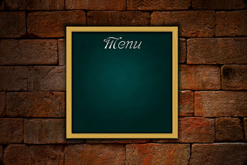 menu on grune green chalkboard and old brickwall background