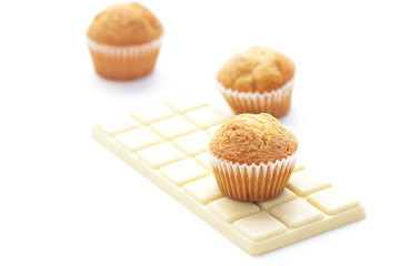 bar of white chocolate and muffin isolated on white