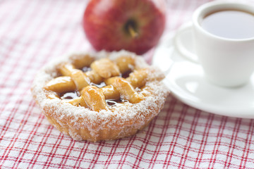 beautiful cake with berries,apple and tea on plaid fabric