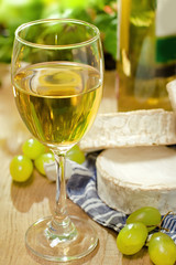 White wine, Brie, Camembert and grape on the table, outdoor