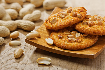 Cookies with peanuts on a square wooden plate