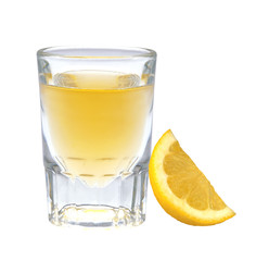 Glass of vodka with pepper and lemon slice isolated on white