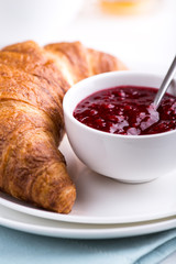 Closeup of croissant and raspberry jam