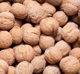 Brown raw walnuts textured background